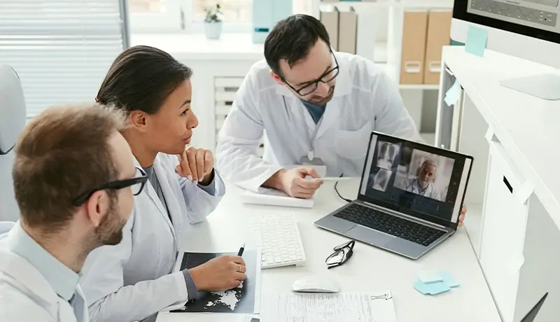 HOMED three doctors at the proxima site discuss with the doctor at the distal site