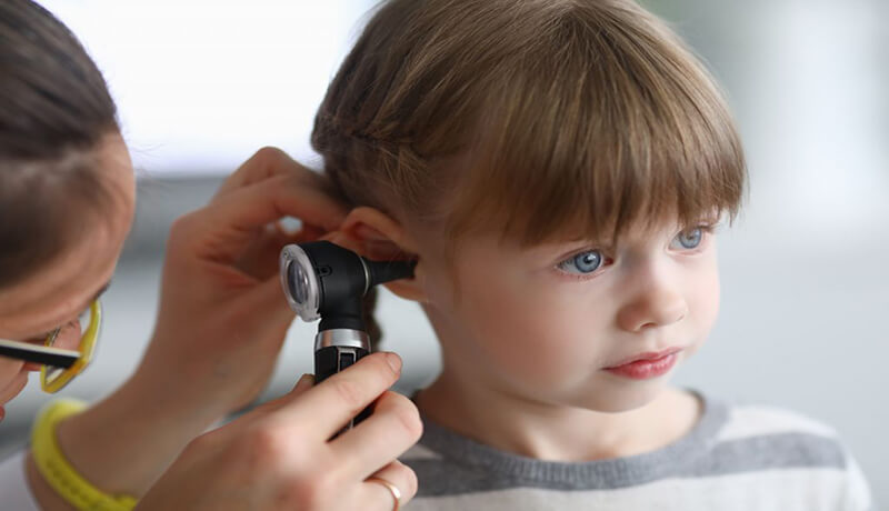 a-doctor-examining-a-child-for-ear-infection by homed doctor Ear Infection Types Treatment