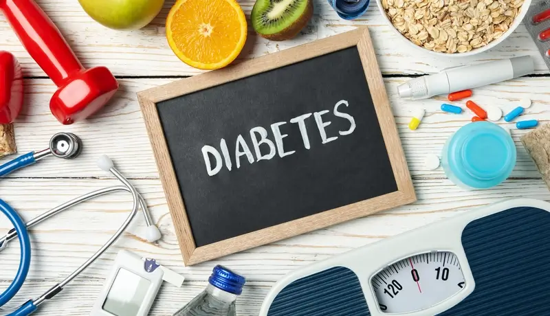 Chalkboard with the word "Diabetes" surrounded by health and nutrition items