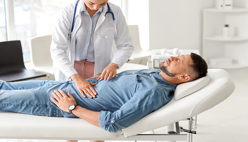 Doctor examining a patient for any abdominal injuries / pain