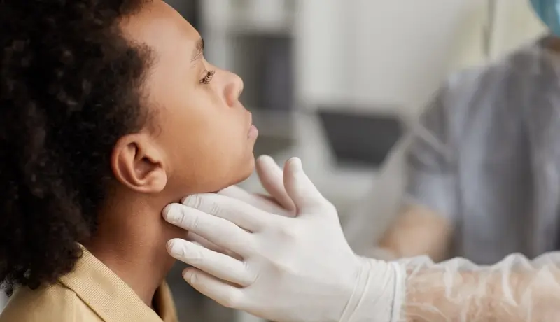 Doctor Examining Boy for Covid