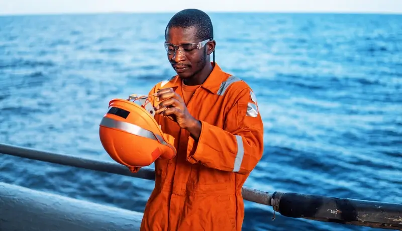 Portrait of engineer on boat at offshore windfarm