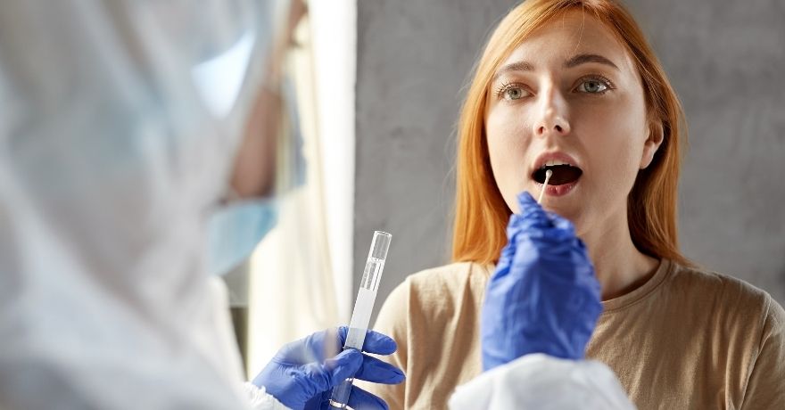 Doctor getting a sample from a patient to perform a fast COVID-19 TEST