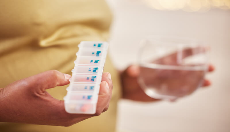 A woman taking his pills