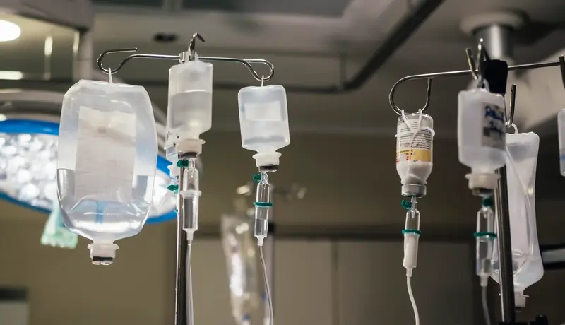 Medical systems with IV drips in a hospital setting, ready to administer fluids to patients.