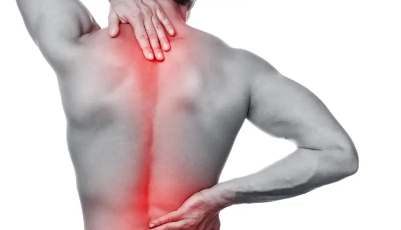 A man showing his upper and lower back in red colour where his signs of pain are located.