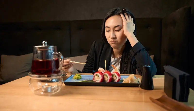 A young woamn being dissapointed by eating
