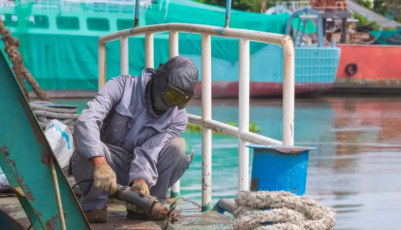 A maritime worker using electric steel cracker