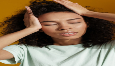Young african woman wearing t-shirt posing with eyes closed
